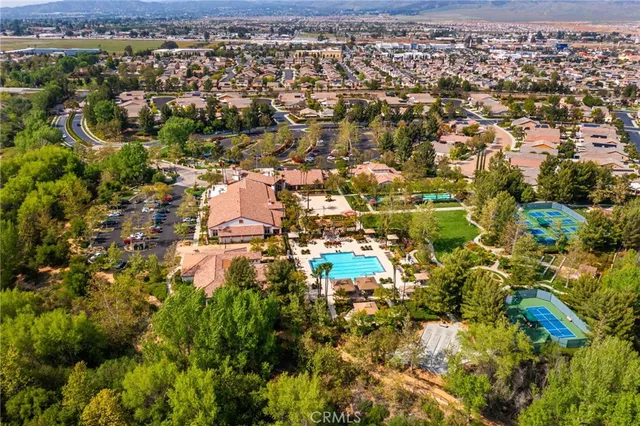 an aerial view of a residential houses with yard