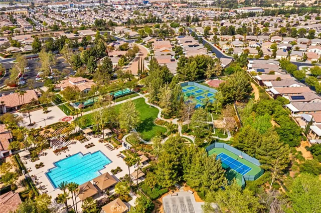 an aerial view of a residential houses with yard