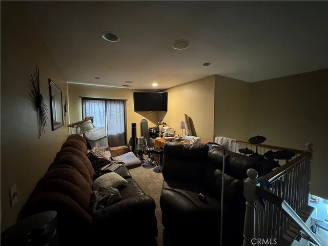 a living room with furniture and a gym machine