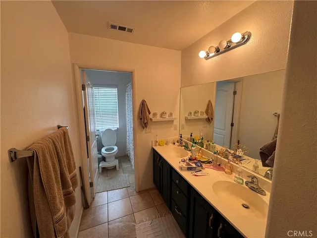 a bathroom with a double vanity sink and mirror