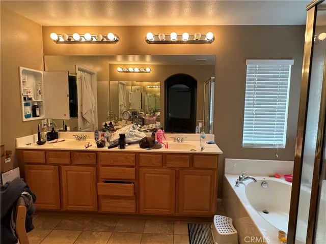 a bathroom with a tub sink and mirror