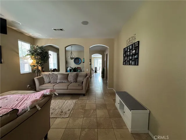 a living room with furniture and a potted plant