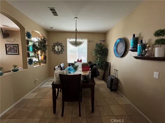 a dining room with furniture and window