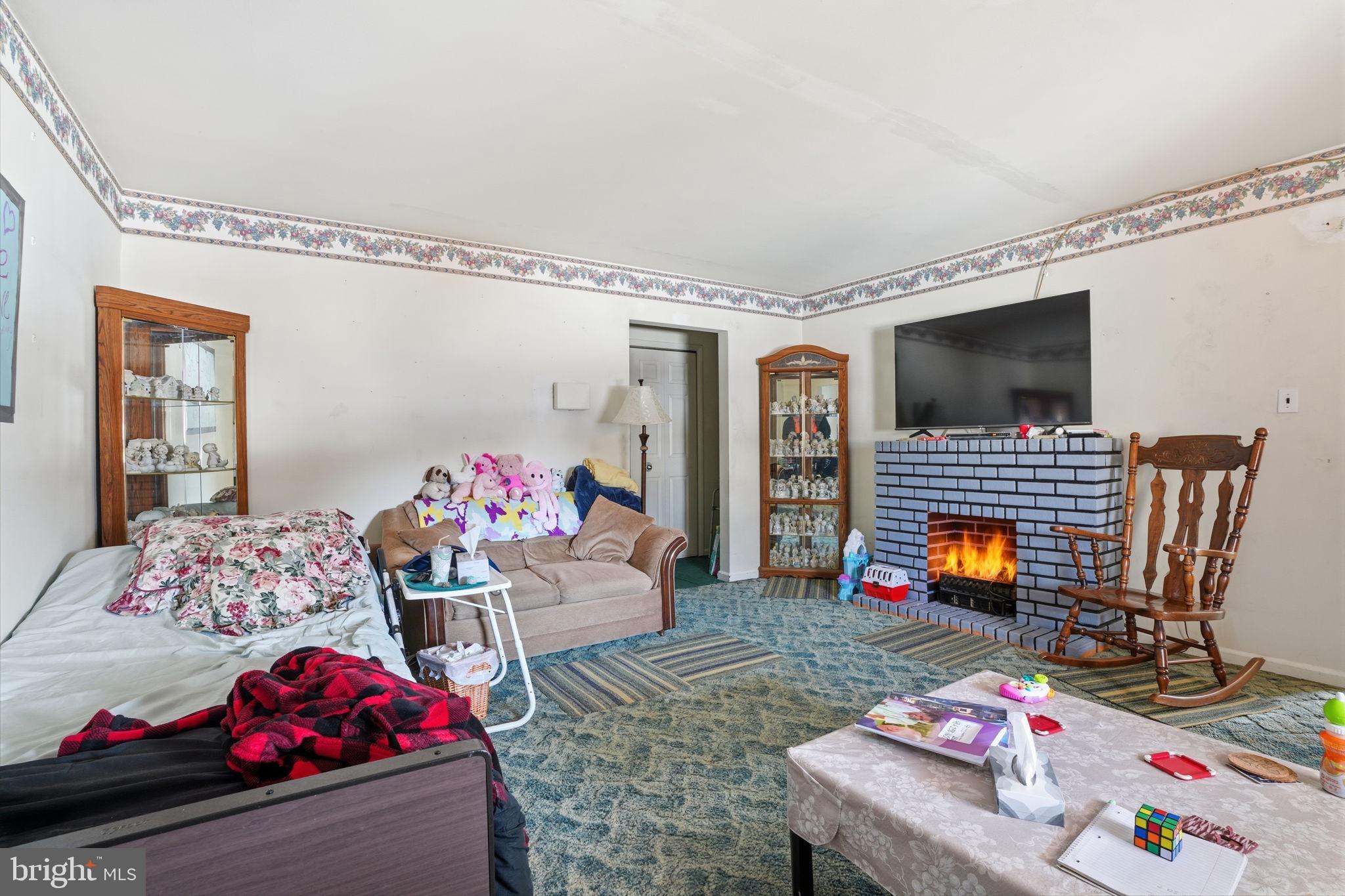 443 Ridge Pike Lafayette Hill, PA 19444 - Photo 11 of 13 a bedroom with furniture and a fireplace