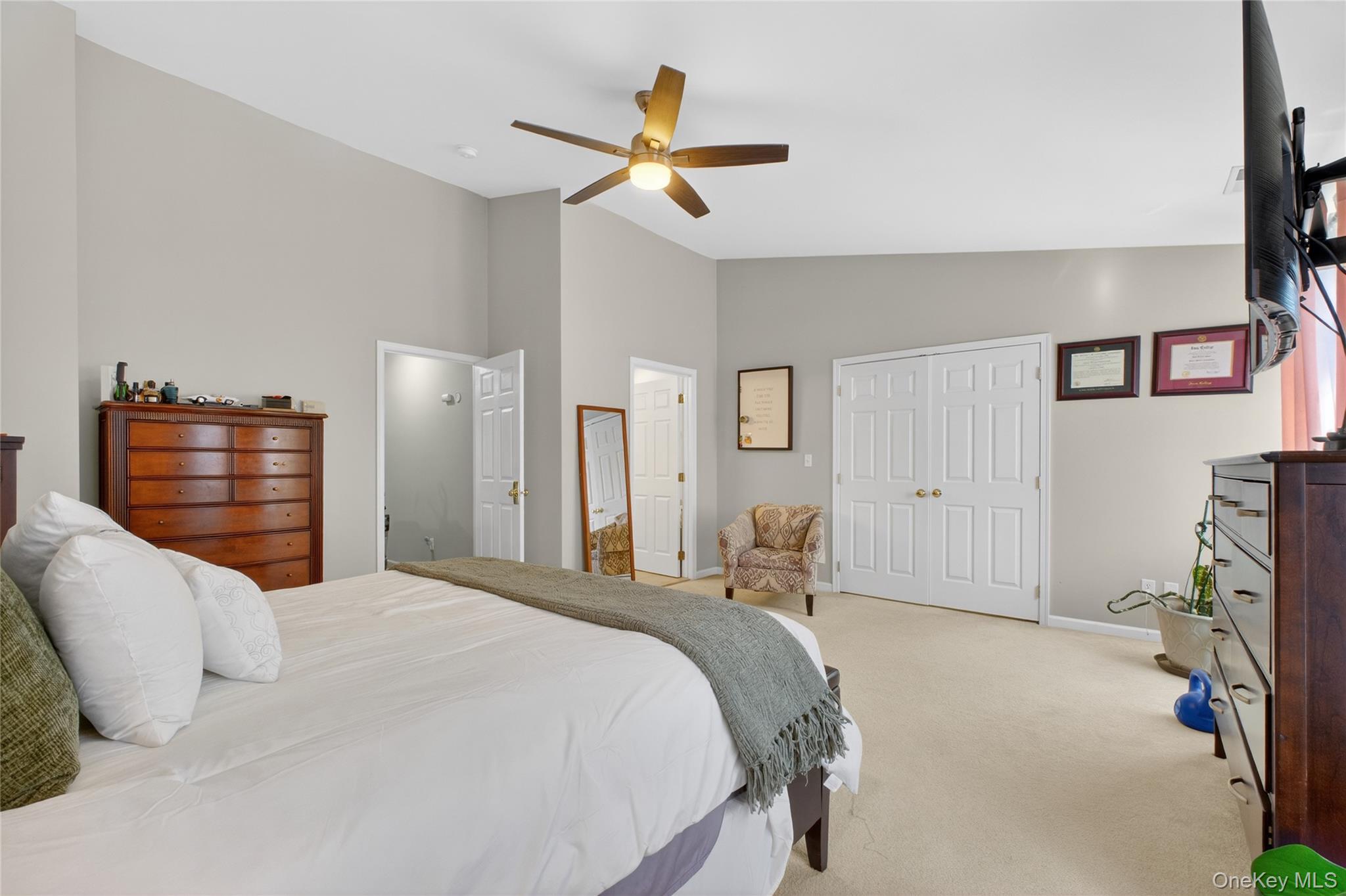 733 Huntington Drive Fishkill, NY 12524 - Photo 12 of 18 Bedroom featuring light colored carpet, lofted ceiling, a closet, ceiling fan, and ensuite bathroom