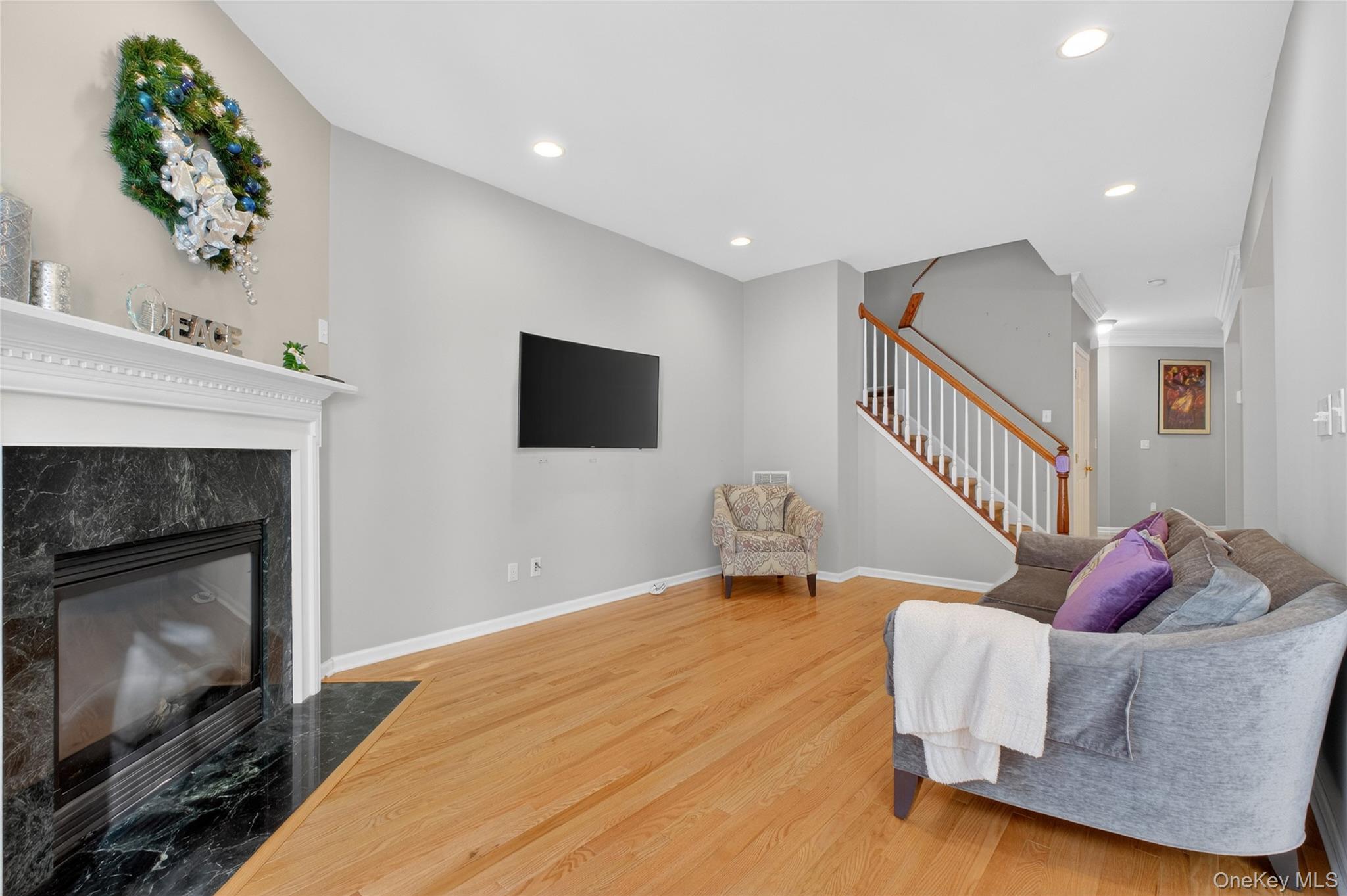 733 Huntington Drive Fishkill, NY 12524 - Photo 9 of 18 Living area with a fireplace, recessed lighting, stairway, and light wood-style flooring