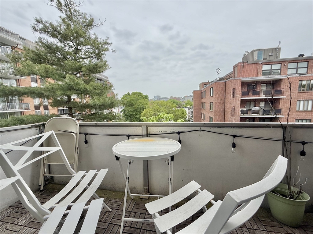 20 Stearns Road, Unit 45 Brookline, MA 02446 - Photo 17 of 22 a balcony with a table and chairs