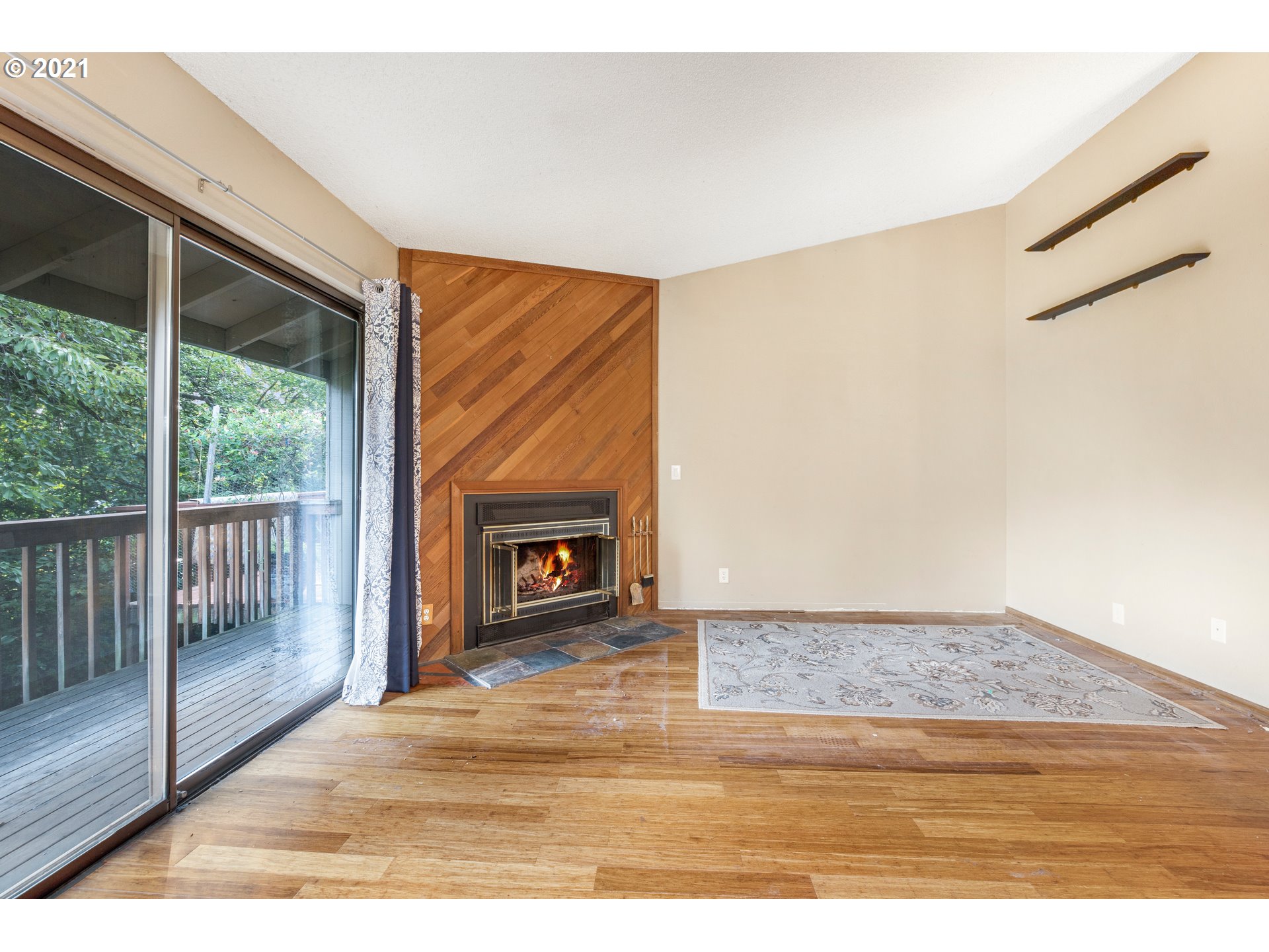 2818 Tree Top Lane West Linn, OR 97068 - Photo 13 of 26 a view of empty room with wooden floor and fireplace