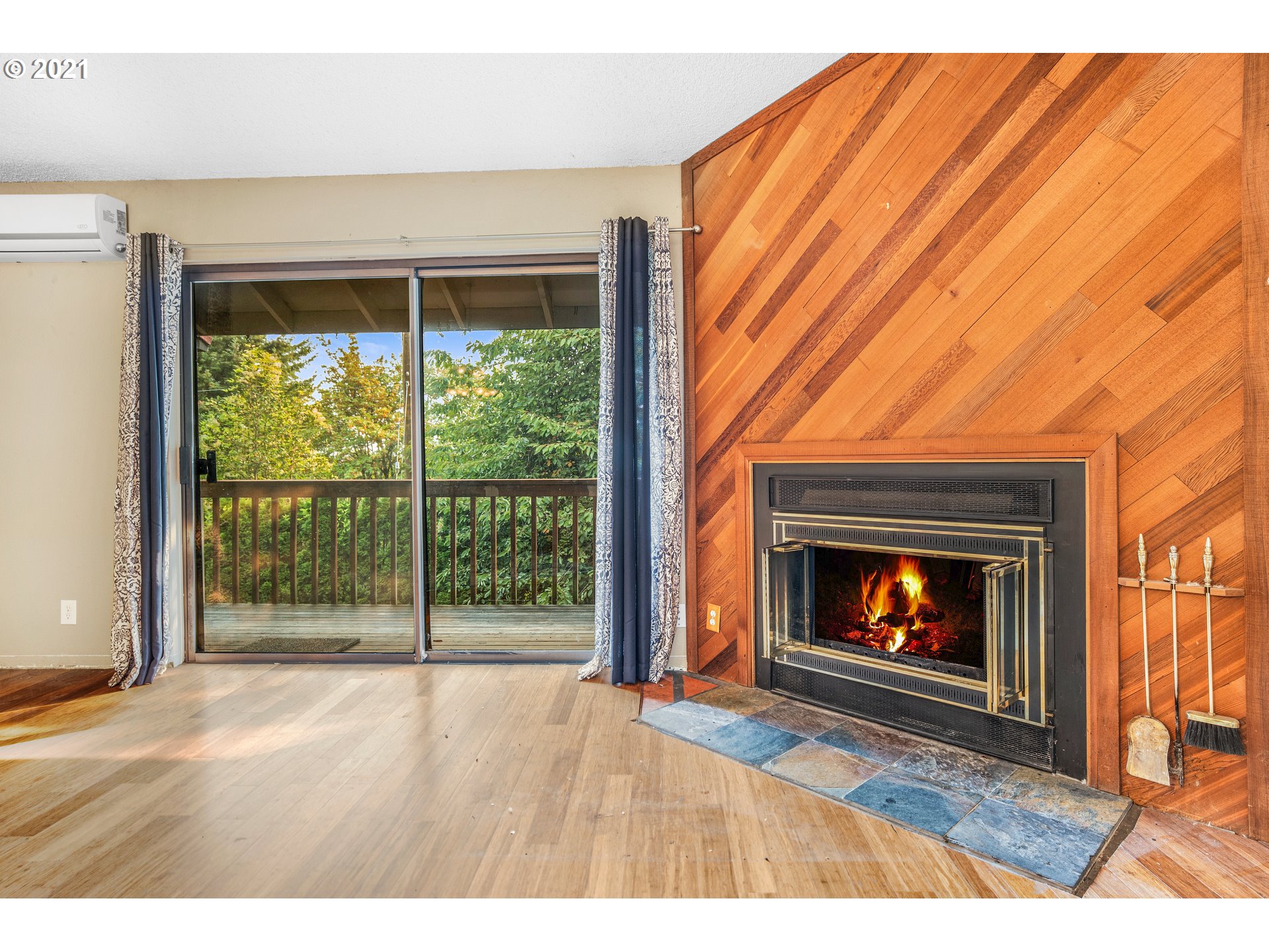 2818 Tree Top Lane West Linn, OR 97068 - Photo 15 of 26 a view of an empty room with wooden floor fireplace and a window