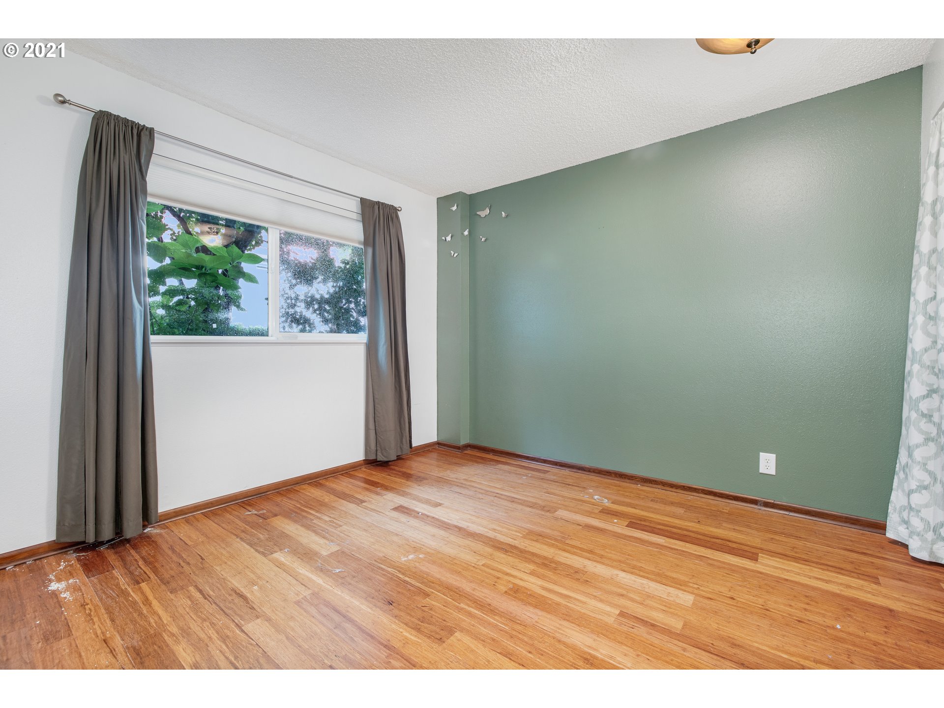 2818 Tree Top Lane West Linn, OR 97068 - Photo 20 of 26 a view of an empty room with wooden floor and a window