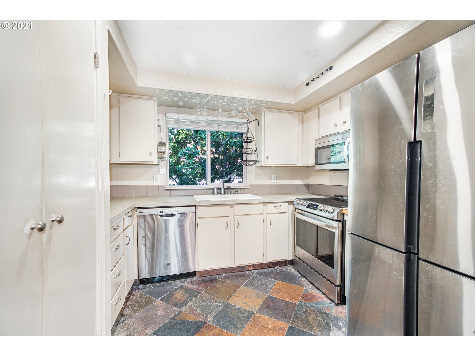 2818 Tree Top Lane West Linn, OR 97068 - Photo 7 of 26 a kitchen with granite countertop stainless steel appliances a refrigerator sink and microwave