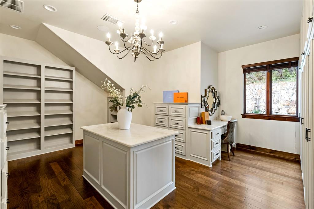 9930 Boat Club Road Fort Worth, TX 76179 - Photo 22 of 40 The primary closet in the Main House features custom cabinetry, ample storage, and a beautifully designed center island.