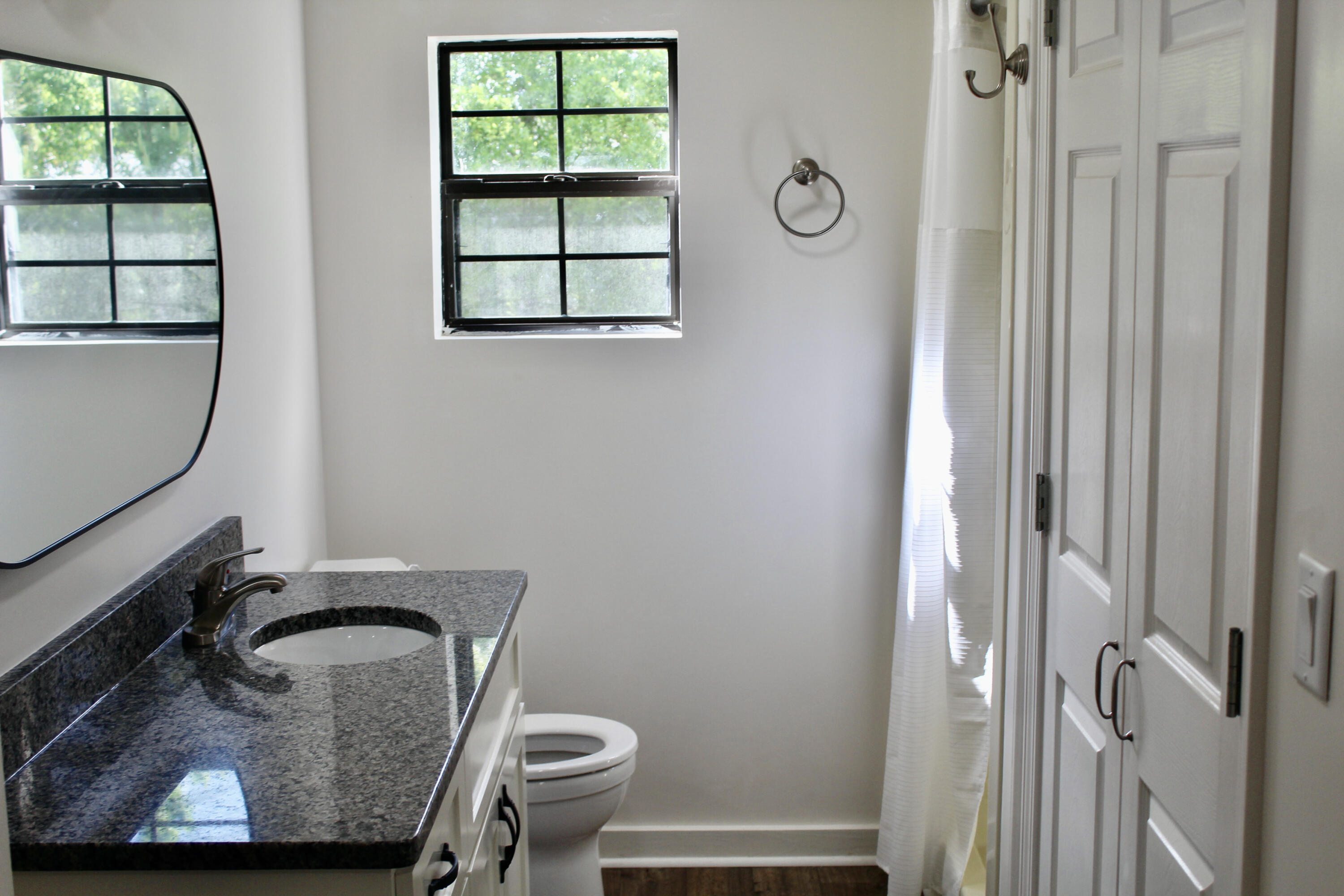 2833 Ponce De Leon Springs Road Ponce de Leon, FL 32455 - Photo 11 of 16 a bathroom with a granite countertop toilet and a sink