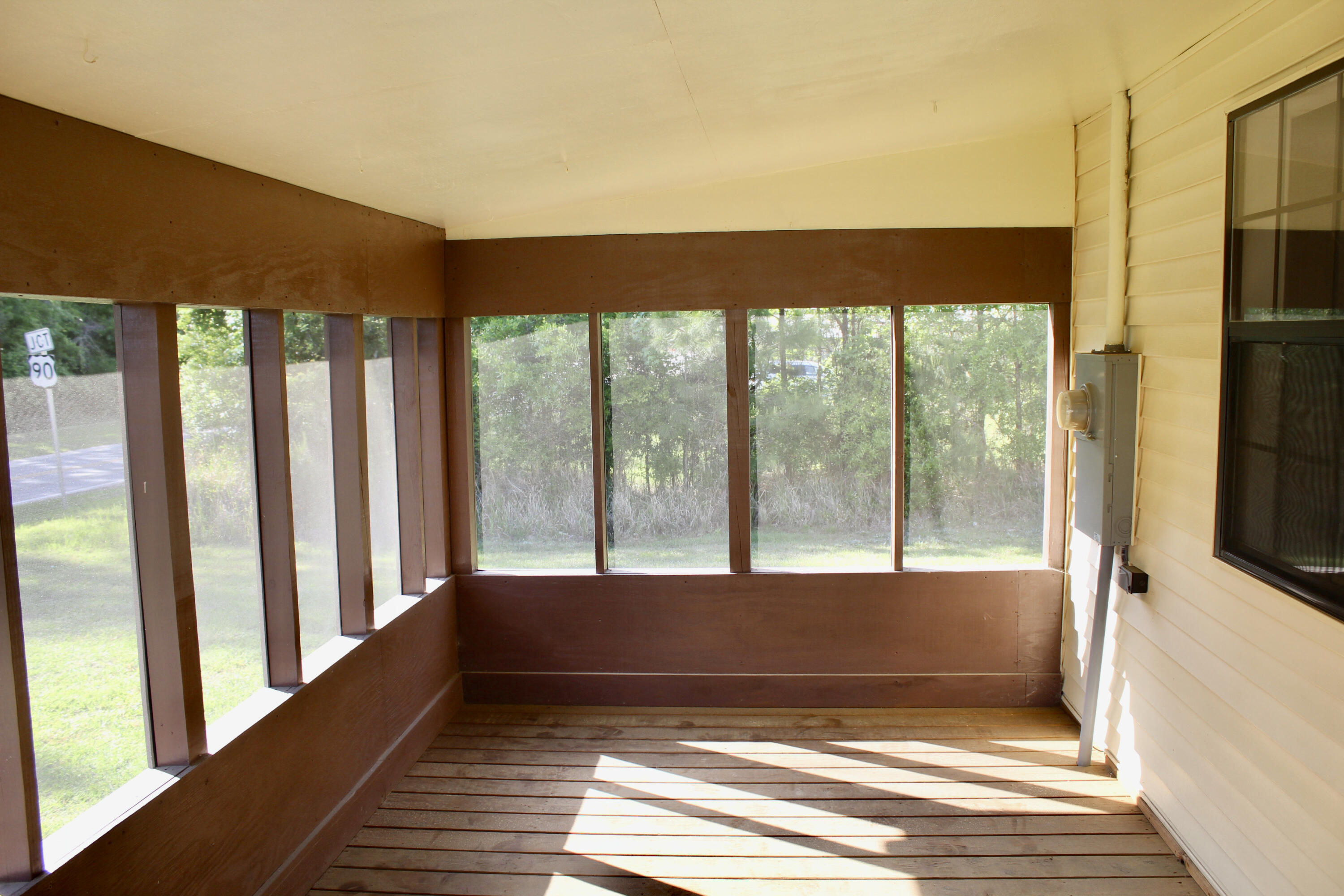 2833 Ponce De Leon Springs Road Ponce de Leon, FL 32455 - Photo 2 of 16 a view of a room with wooden floor and a floor to ceiling window