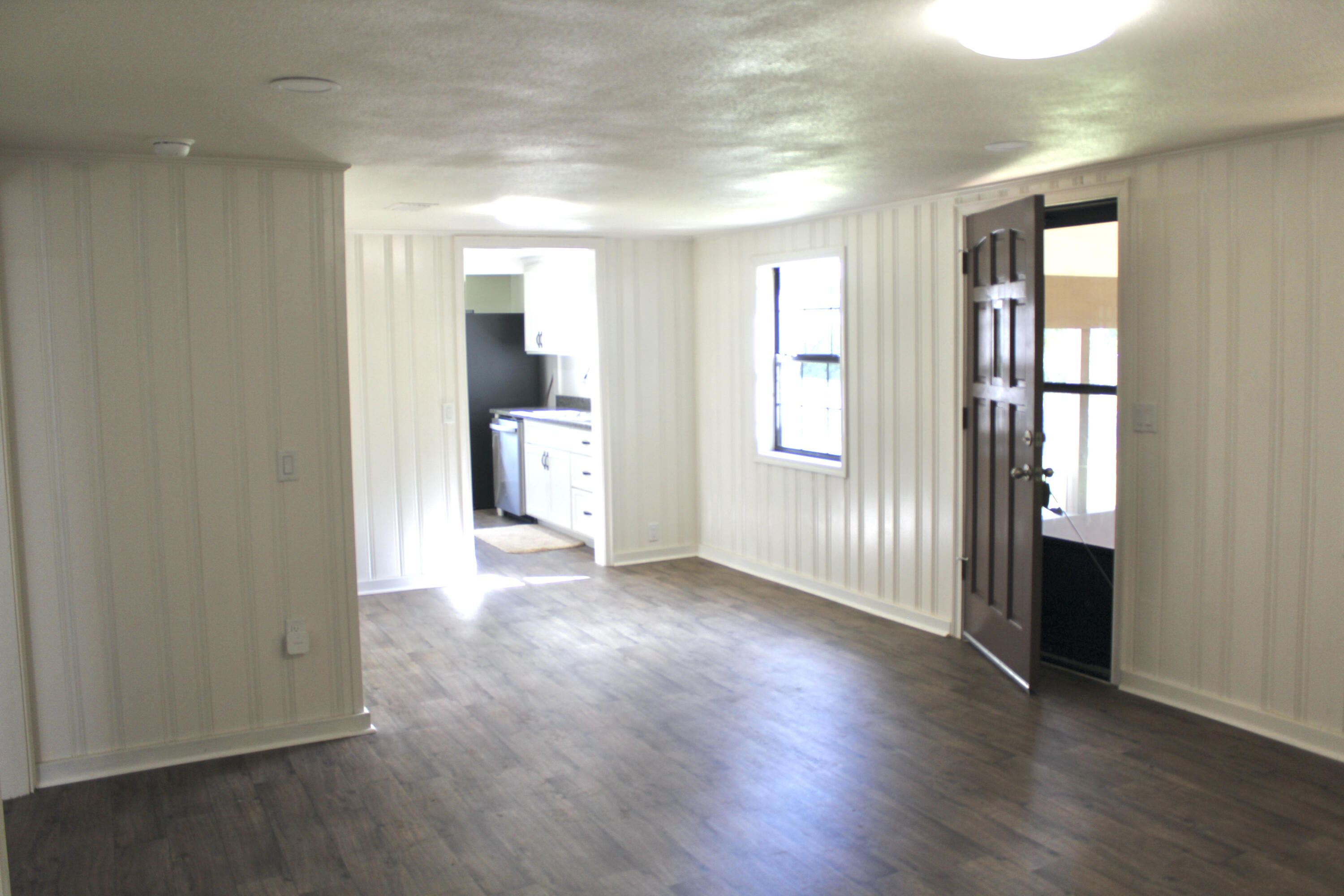 2833 Ponce De Leon Springs Road Ponce de Leon, FL 32455 - Photo 3 of 16 an empty room with wooden floor and windows
