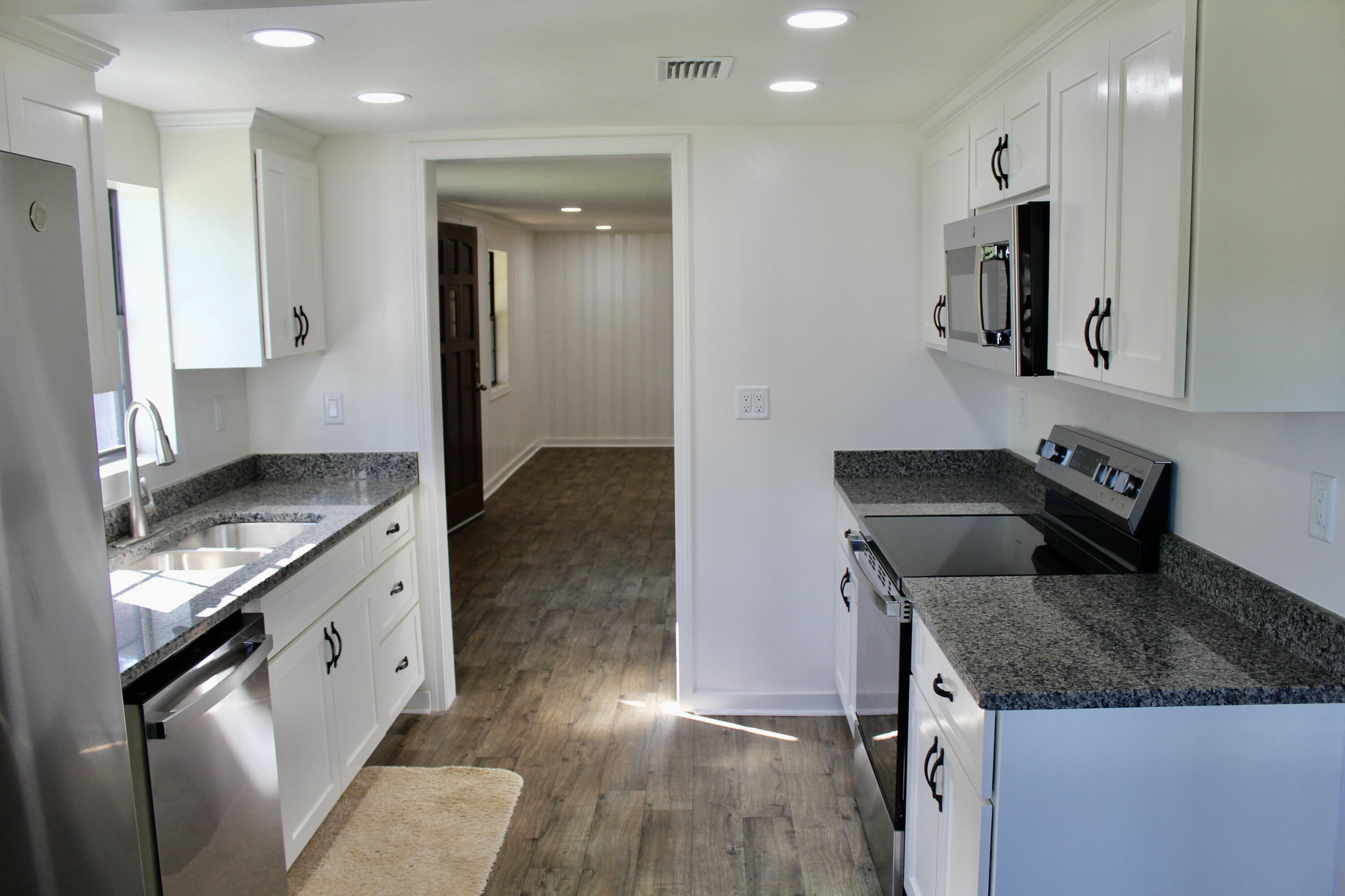 2833 Ponce De Leon Springs Road Ponce de Leon, FL 32455 - Photo 6 of 16 a kitchen with a sink stove and refrigerator