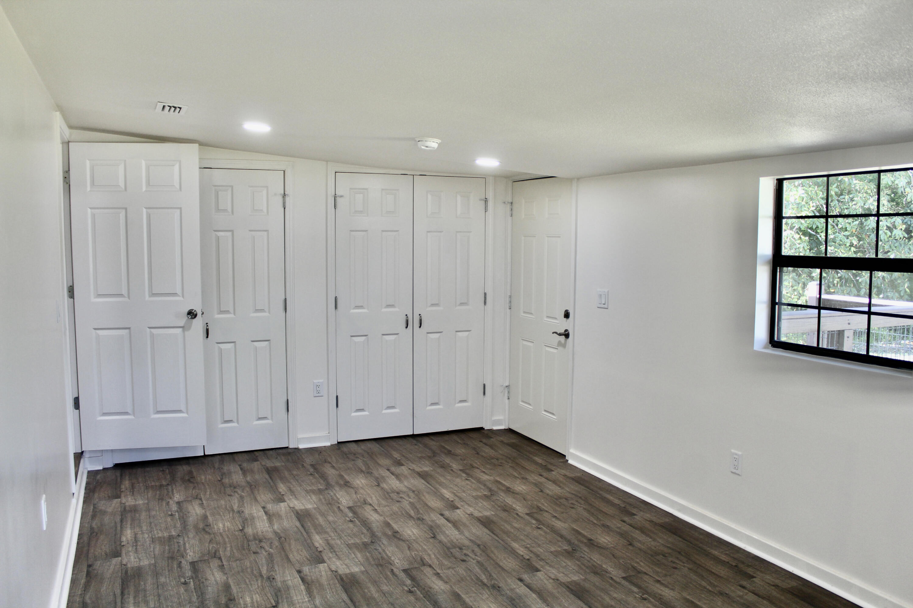2833 Ponce De Leon Springs Road Ponce de Leon, FL 32455 - Photo 8 of 16 a view of a room with wooden floor and window