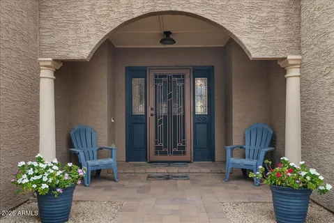 a view of a hallway with entryway wooden floor and front door