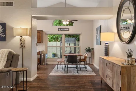 a living room with furniture flat screen tv and wooden floor