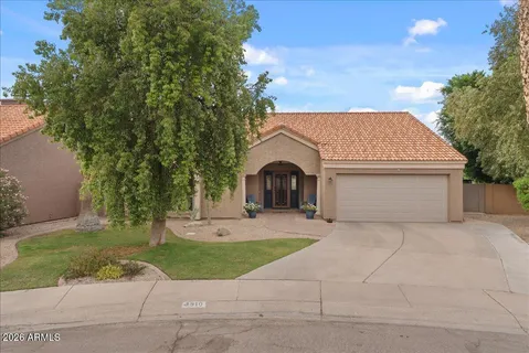 a front view of a house with outdoor seating
