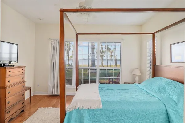 a living room with furniture a floor to ceiling window and outdoor view