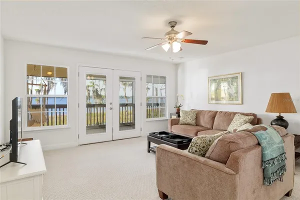 a kitchen with stainless steel appliances granite countertop a stove a refrigerator a kitchen island a sink dishwasher a dining table and chairs with wooden floor