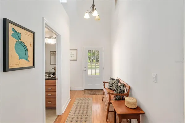 a living room with furniture kitchen view and a large window