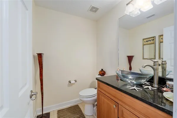 a living room with furniture kitchen view and a large window