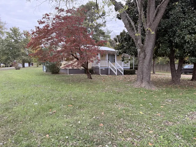 a view of a tree in front of a house