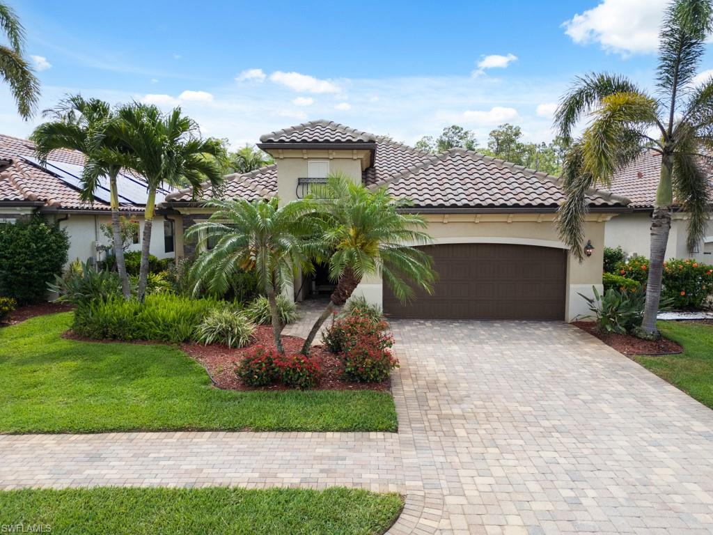 9522 Piacere Way Naples, FL 34113 - Photo 3 of 48 Mediterranean / spanish-style house featuring an attached garage, decorative driveway, stucco siding, and a tiled roof