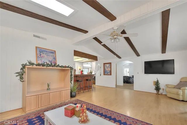 a living room with furniture and a floor to ceiling window