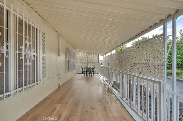 a dining hall with stainless steel appliances kitchen island a table and chairs in it