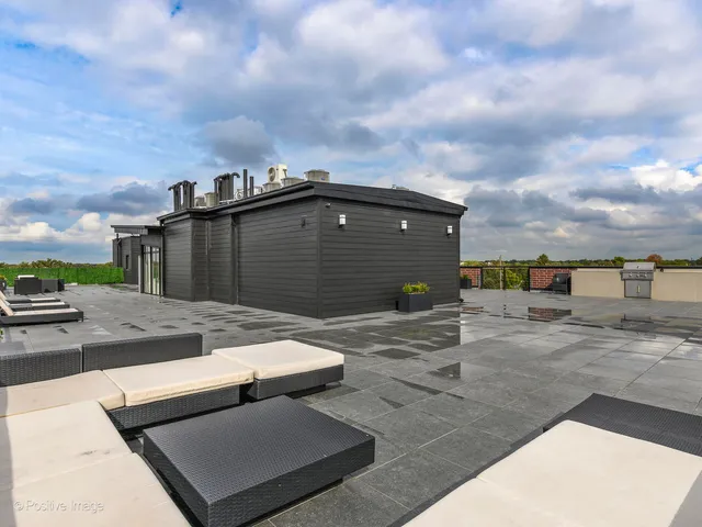 a terrace view with barbeque oven and seating space
