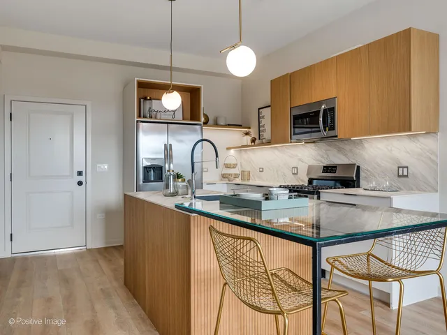 a kitchen with stainless steel appliances granite countertop a sink a stove and a microwave