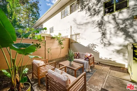 a backyard of a house with table and chairs