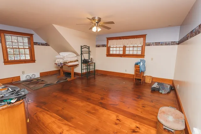 a view of a livingroom with furniture a ceiling fan and window