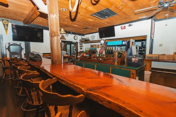 a roof deck with furniture and wooden floor