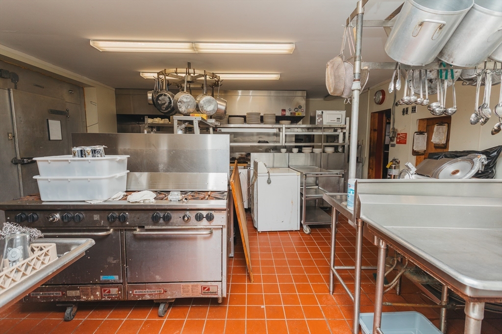 559 Tea Street Charlemont, MA 01339 - Photo 30 of 38 a kitchen with a stove a refrigerator and cabinets