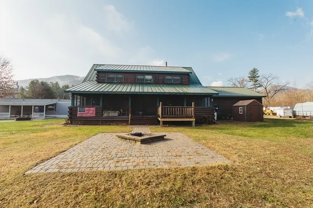 a view of a house with swimming pool and a yard
