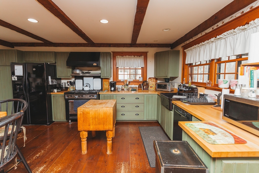 559 Tea Street Charlemont, MA 01339 - Photo 5 of 38 a kitchen with stainless steel appliances granite countertop a stove a sink dishwasher and a refrigerator with wooden floor