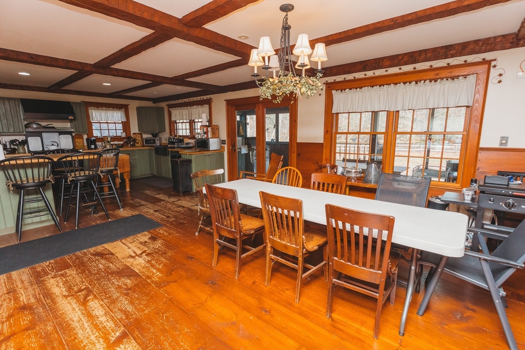 559 Tea Street Charlemont, MA 01339 - Photo 8 of 38 a dining room with furniture a chandelier and wooden floor