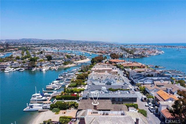 a living room with furniture potted plant and a large window