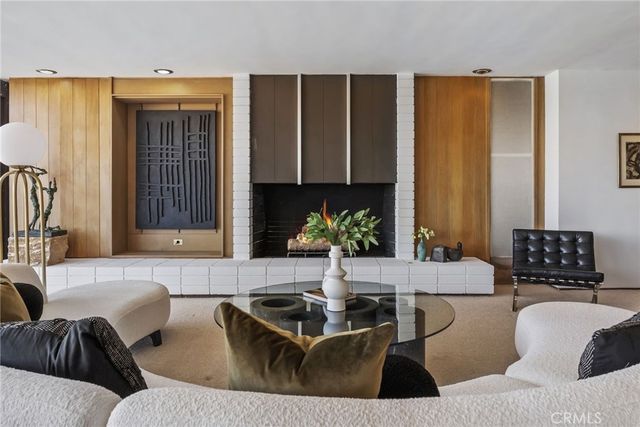 a bedroom with furniture and a balcony