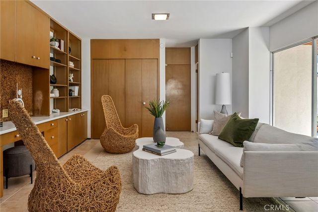 a bedroom with a bed and a plant