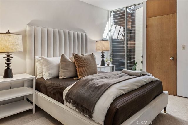 a bedroom with a large bed and a balcony