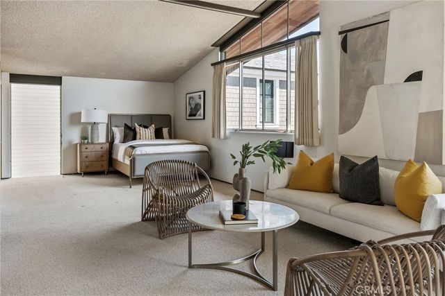 a front view of a house with a garden and balcony