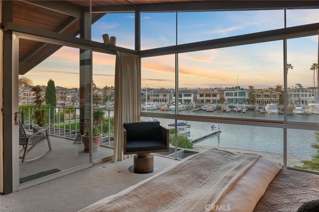 an aerial view of a city with ocean view in back