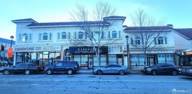 a view of building with cars park in front of building