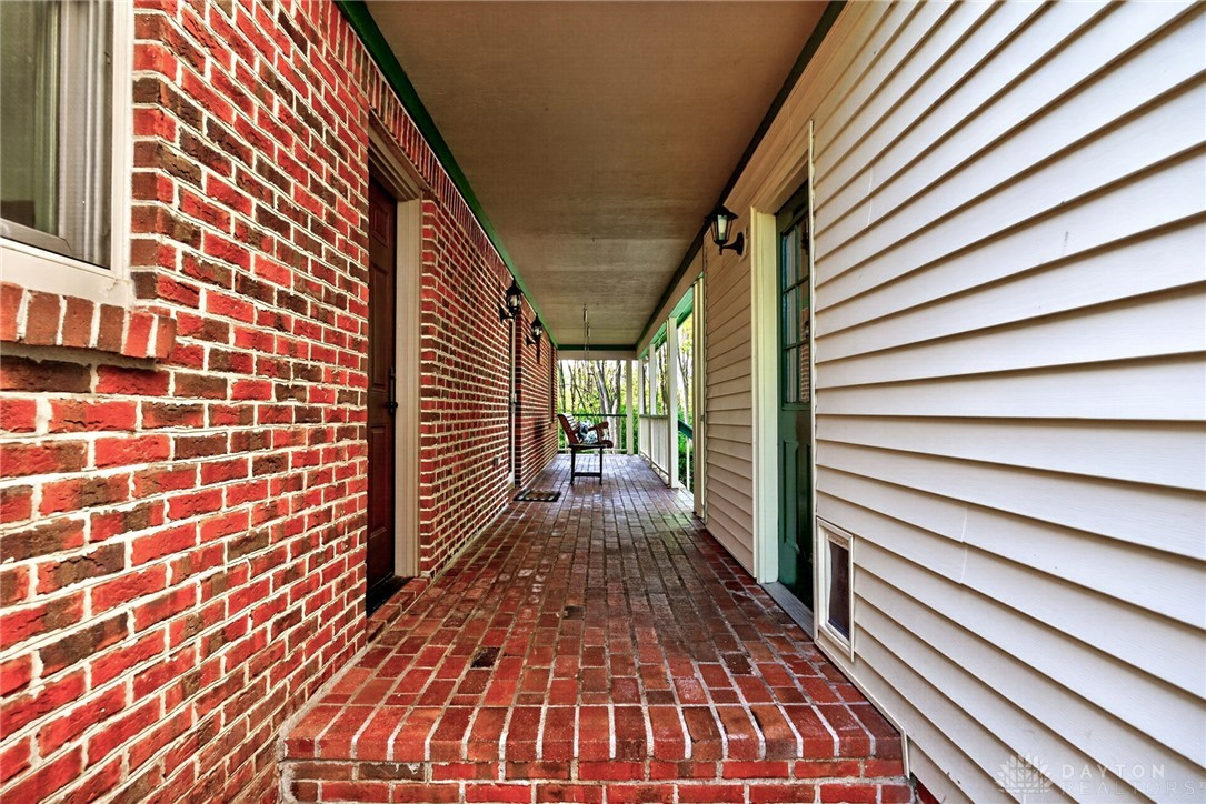 330 South Alpha Bellbrook Road Bellbrook, OH 45305 - Photo 63 of 87 This inviting porch, featuring brick flooring, offers a peaceful outdoor retreat.