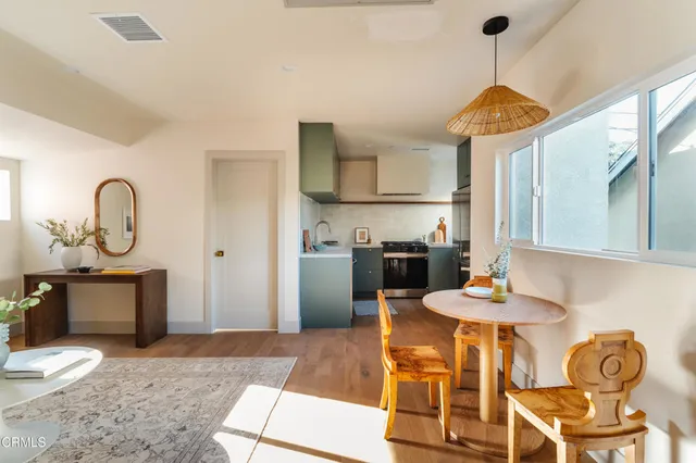 a kitchen with stainless steel appliances granite countertop a sink a stove and a wooden floors